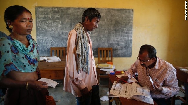 A polling officer in Agartala looks for a voter's name in the registered voter list April 7.