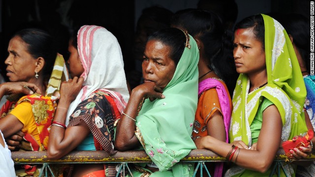 Women voters wait outside a polling station in Dibrugarh on April 7.