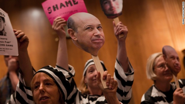 Today, the top 1% controls about 40% of national wealth. At a hearing in Washington D.C. about Wall Street and the financial crisis, protesters hold a placard depicting Goldman Sachs CEO Lloyd Blankfein, who once famously said, "I'm doing God's work."<!-- -->
</br>