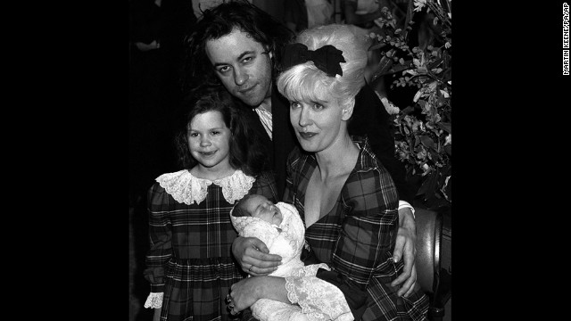 Peaches is held by Yates in a portrait with Bob and sister Fifi Trixiebelle in March 1989.