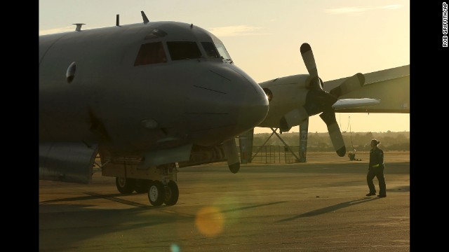 A member of the Royal Australian Air Force walks toward a plane that just arrived in Perth on April 8.