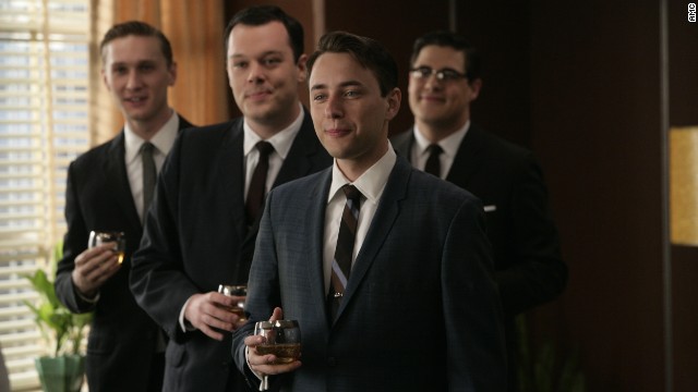 Wearing dark, formal suits was a nearly century-old tradition by the time "Mad Men" ad men donned identical looks -- with highballs -- at the Sterling Cooper agency in 1960. Their suits' slim silhouettes came from the returning WWII soldiers' athletic figures, said University of Notre Dame history professor and author Linda Przybyszewski. Suits narrowed in the shoulders, torso and legs to fit the new physique.