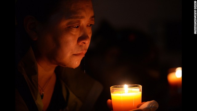 A relative of a missing passenger cries at a vigil in Beijing on Tuesday, April 8.