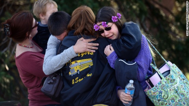 Parents and students embrace near Franklin Regional High School, where authorities say at least 20 people were injured in a stabbing spree Wednesday, April 9, in Murrysville, Pennsylvania.