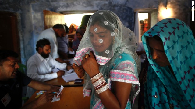 Voters wait for their identities to be verified before casting their ballots April 10 in Haryana, India.