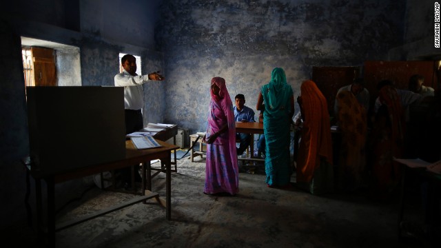 A woman is given directions by a polling station officer in Haryana on April 10.