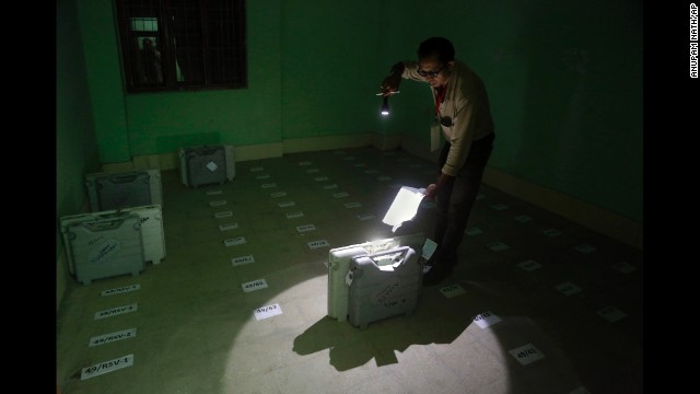 A polling officer checks the number of an electronic voting machine after it was deposited in Senapati, India, on Wednesday, April 9.