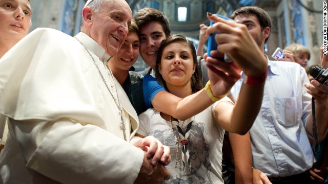 Francis has his picture taken inside St. Peter's Basilica with youths who came to Rome for a pilgrimage in August.