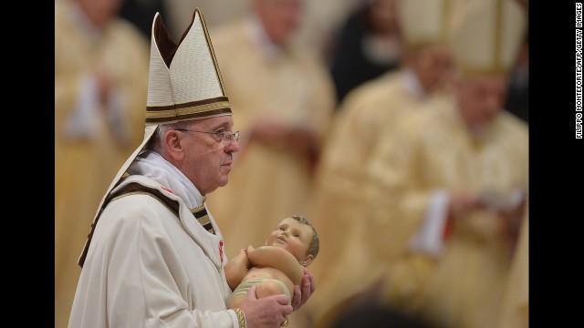 The Pope holds a baby Jesus during a Christmas Eve Mass held at St. Peter's Basilica in the Vatican in 2013.