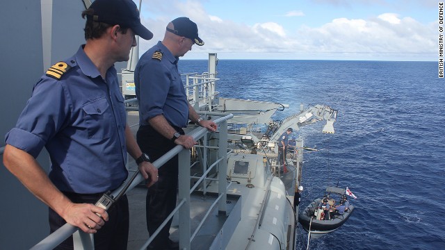 Crew members aboard the Echo watch a smaller boat that's part of the British search effort on April 13.