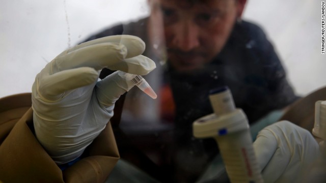 A scientist separates blood cells from plasma cells to isolate any Ebola RNA and test for the virus Thursday, April 3, at the European Mobile Laboratory in Gueckedou, Guinea.