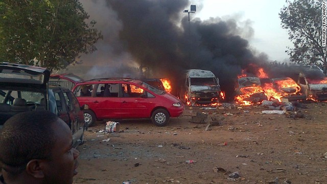 Vehicles are on fire after an explosion Monday, April 14, at a bus station on the outskirts of Abuja, Nigeria. At least 71 people were killed and 124 injured when a parked vehicle exploded at the Nyanya Motor Park bus station, Nigerian officials said.