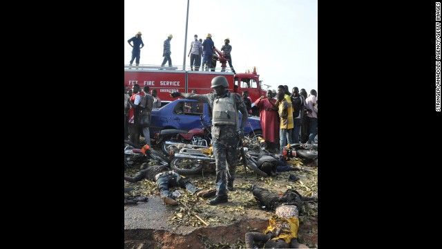 Nigerian security forces gather at the site of the blast April 14. The bus station was crowded with commuters when the explosion happened at about 6:45 a.m.