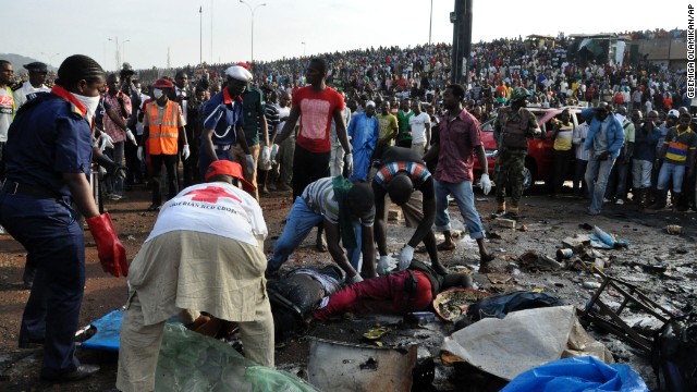 Rescue workers collect the bodies of victims as people gather at the site of the blast on April 14.