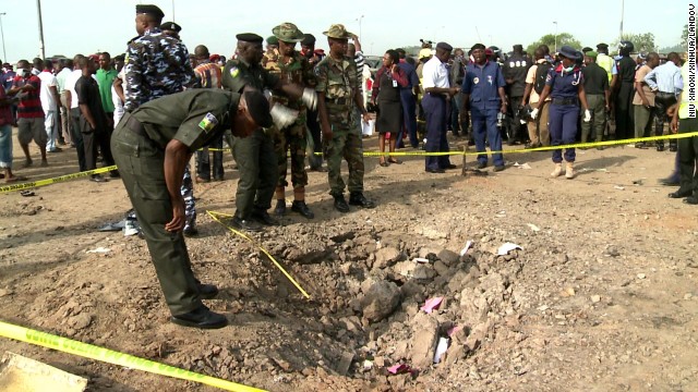 Security personnel inspect the blast site on April 14.