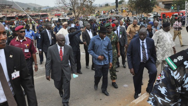 Nigerian President Goodluck Jonathan, wearing the blue shirt and black hat, visits the blast site on April 14. 