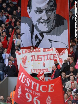 Fans in the Kop stand at Anfield wave banners in memory of the 96 victims of the 1989 disaster, which happened when supporters were crushed during Liverpool's FA Cup semifinal against Nottingham Forest. 