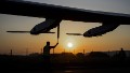 A staff stands next to the propellers of Sun-powered plane Solar Impulse 2 HB-SIB seen in silhouette during its first exit for test on April 14, 2014 in Payerne, a year ahead of their planned round-the-world flight. Solar Impulse 2 is the successor of the original plane of the same name, which last year completed a trip across the United States without using a drop of fuel. AFP PHOTO / FABRICE COFFRINI (Photo credit should read FABRICE COFFRINI/AFP/Getty Images)