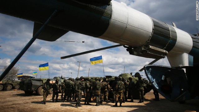 Ukrainian troops receive munitions at a field on the outskirts of Izium, Ukraine, on April 15.