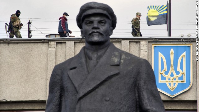 Armed pro-Russian activists stand guard on top of a Ukrainian regional administration building in Slavyansk on Monday, April 14.