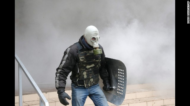 A pro-Russian activist carries a shield during the mass storming of a police station in Horlivka, Ukraine, on April 14.