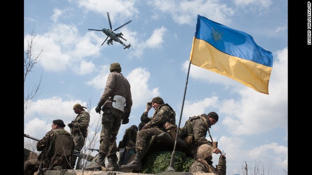 A Ukrainian helicopter flies over a column of Ukrainian Army combat vehicles on the way to Kramatorsk, a city in eastern Ukraine, on April 16.