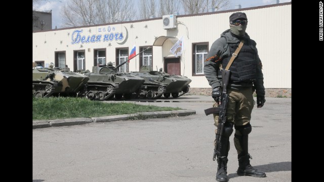 A masked pro-Russian gunman guards combat vehicles parked in downtown Slaviansk on April 16.