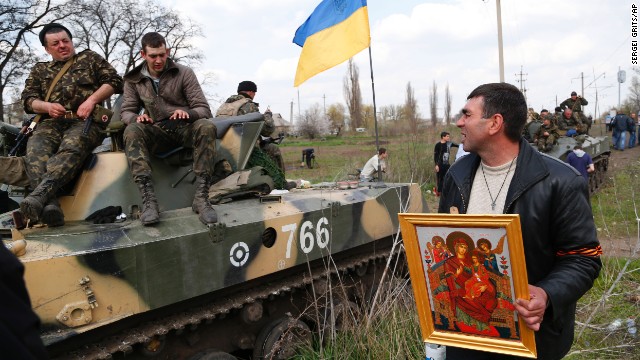 A man talks with Ukrainian soldiers as they are blocked by people on their way to Kramatorsk.