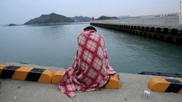 A relative waits for a missing loved one at the port in Jindo.