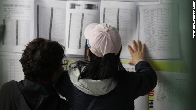 Relatives check a list of survivors April 16 in Jindo.