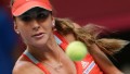 Suisse's Belinda Bencic returns the ball to France's Alize Cornet during the second match of the Fed Cup first round tennis tie France vs Switzerland on February 8, 2014 at the Pierre de Coubertin stadium in Paris. AFP PHOTO / KENZO TRIBOUILLARD (Photo credit should read KENZO TRIBOUILLARD/AFP/Getty Images)