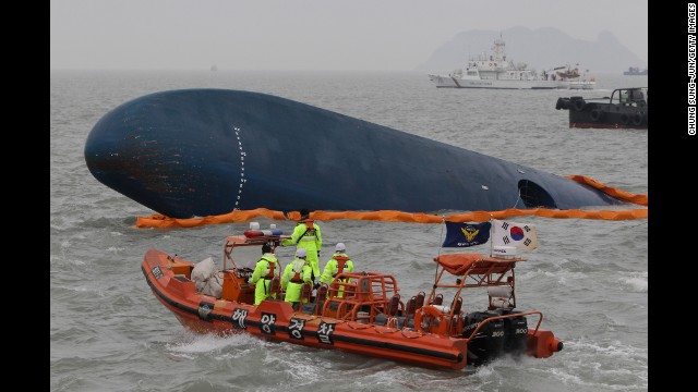 South Korean coast guard members and rescue teams search for passengers at the site of the sunken ferry on April 17.