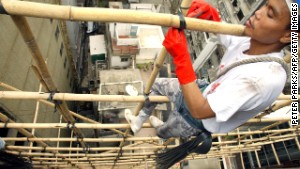 Hong Kong\'s scaffolders dangle precariously on bits of bamboo.