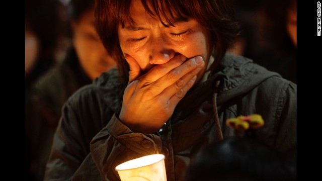 A woman cries during a candlelight vigil at Danwon High School in Ansan, South Korea, on April 17. Most of the people on board the ferry were high school students on their way to the resort island of Jeju.