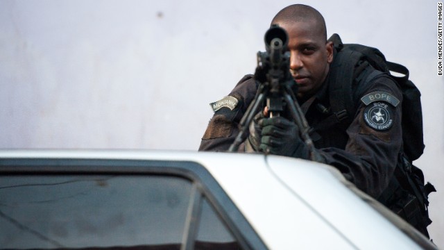 A police officer keeps watch March 30 in the Complexo da Mare. 