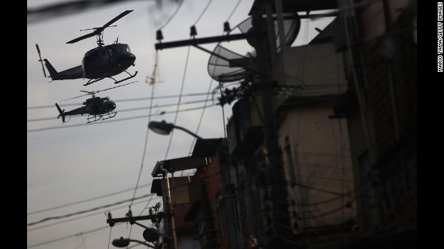 Police helicopters patrol over the favela.