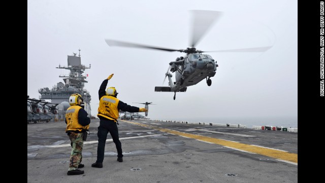 A U.S. helicopter takes off from the flight deck of the USS Bonhomme Richard during search-and-rescue operations on April 18.