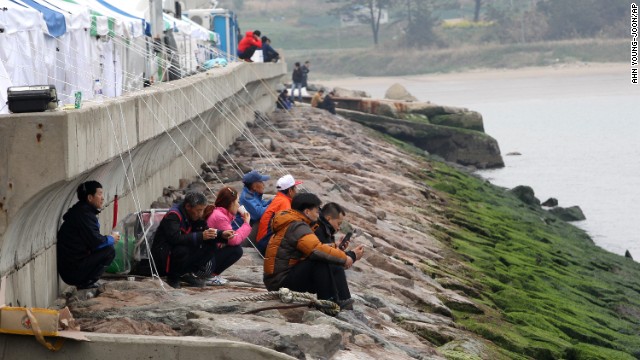 Relatives of missing passengers wait on the shore in Jindo on April 19.