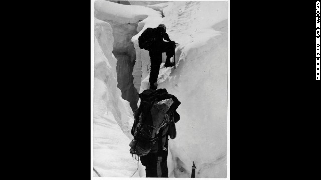 Hillary and Nepalese-Indian mountaineer Tenzing Norgay climb beyond a crevasse on Mount Everest in 1953. Upon meeting George Lowe, who had climbed up to meet the descending duo, Hillary reportedly exclaimed, "Well George, we knocked the bastard off!"