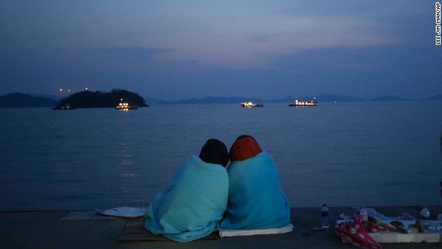 Relatives of passengers look out at the sea from Jindo on April 20.