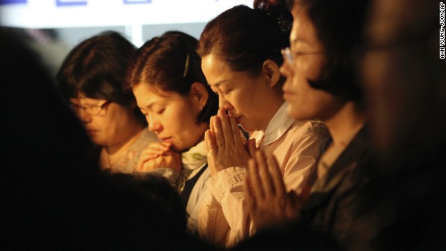 Family members of missing passengers pray during an Easter service in Jindo on April 20.