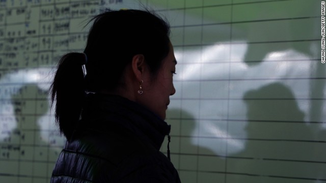 A relative of a passenger looks at the lists of the dead in Jindo on April 21.