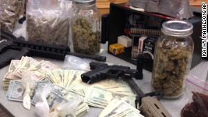 Authorities seized stacks of cash and some semi-automatic weapons