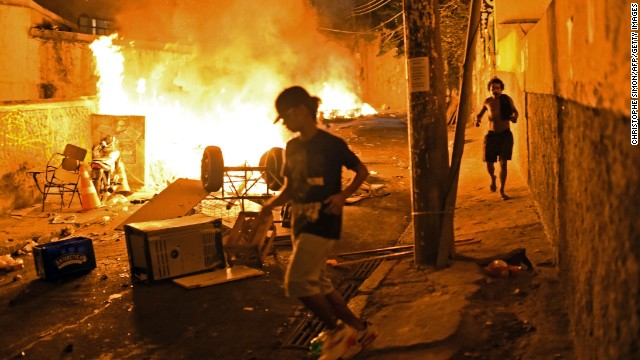 Residents run for cover during violent clashes between protesters and police.