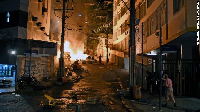 A local stands next to a fire during the protest.