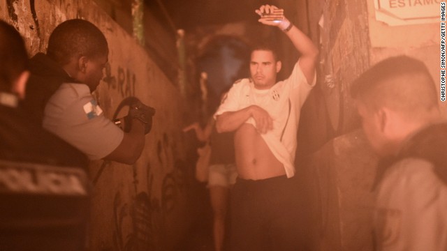 Brazilian police detain a man during a violent protest in the Pavao-Pavaozinho community near Copacabana Beach in Rio de Janeiro on Tuesday, April 22. Residents took to the streets after a young male dancer was found dead, state-run Agencia Brasil said. The residents told Brazilian media they blame the police for the death. 