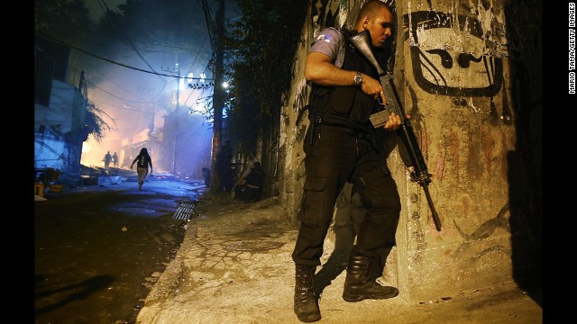 A police officer patrols a street just blocks from Copacabana Beach.