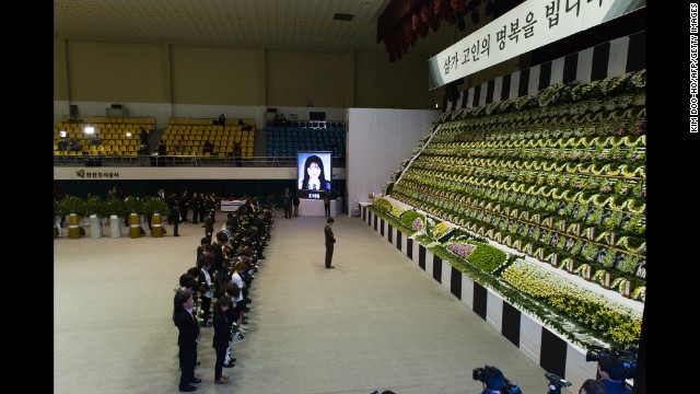 People attend a memorial for the victims at Olympic Memorial Hall in Ansan.