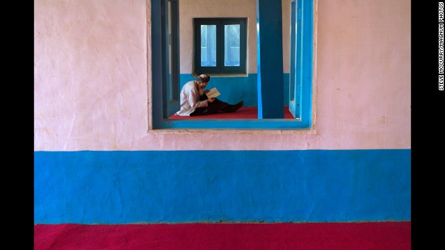 A man reads at a mosque in Bamiyan, 2006.