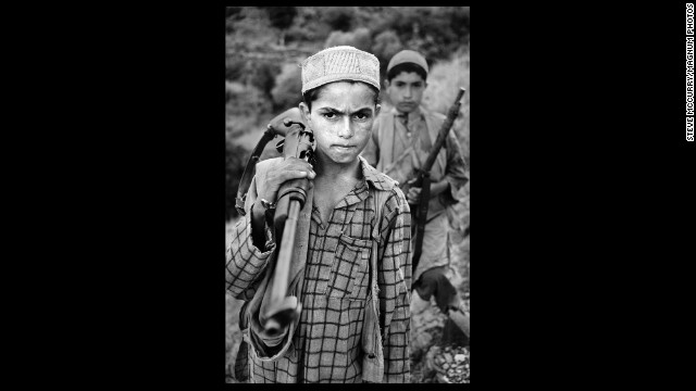 A young boy stands with his gun, 1979.